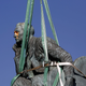 The statue of Cecil John Rhodes is bound by straps as it awaits removal from the University of Cape Town (UCT), Apr. 9, 2015
